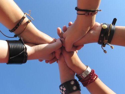 five friends holding hands